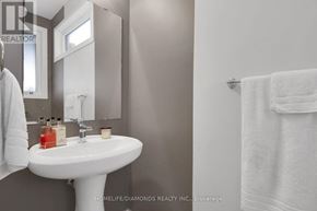 London North (North M) townhouse for rent - A white sink in a bathroom with a towel hanging on the wall.