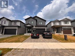 London South (South W) apartment for rent - A realtor photo of a house with two cars parked in front.
