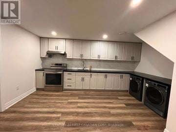 London South (South W) apartment for rent - A kitchen with wooden floors and white cabinets.