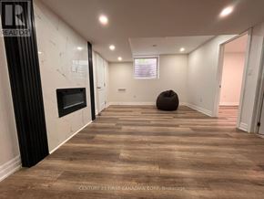 London South (South W) apartment for rent - A spacious room with wooden flooring and a fireplace.