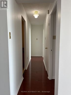 Toronto (Newtonbrook West) condo for rent - A long hallway with white walls and a light on.