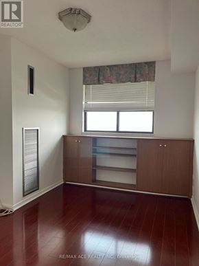 Toronto (Newtonbrook West) condo for rent - A room with a wooden floor and a window with blinds.