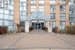 Toronto (Guildwood) condo for rent - The entrance to a building with a glass door and a metal gate.