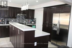 Brampton (Fletcher's Meadow) apartment for rent - A kitchen with dark brown cabinets and a white countertop.
