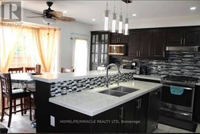 Brampton (Fletcher's Meadow) apartment for rent - A modern kitchen with a large island in the center.