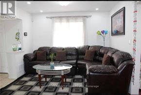 Brampton (Fletcher's Meadow) apartment for rent - A living room with a brown leather couch and a glass coffee table.