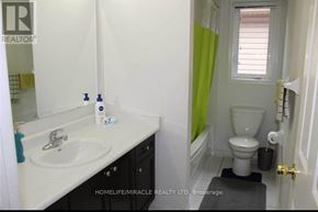 Brampton (Fletcher's Meadow) apartment for rent - A bathroom with a sink, toilet, and a mirror.