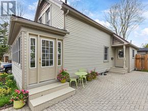 Brockville apartment for rent - A house with a patio and a table set up outside.