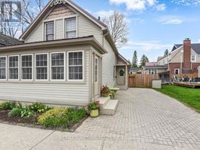 Brockville apartment for rent - A house with a grey exterior and a brick walkway in front.