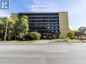 Toronto (Wexford-Maryvale) multi-family for rent - A large building with a sign that says "REALTOR" on the top left corner.