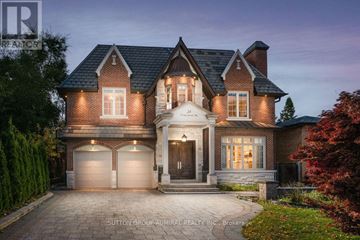 Toronto (Newtonbrook East) apartment for rent - A large, two-story house with a brick facade and a large front yard.