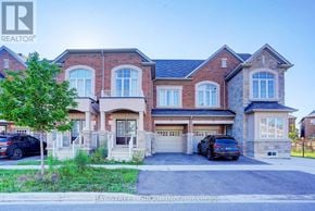 Richmond Hill townhouse for rent - A large brick house with a bay window and a garage.