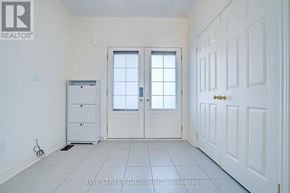 Richmond Hill townhouse for rent - A white room with a door, a window, and a cabinet.