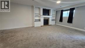 Windsor apartment for rent - A spacious living room with a fireplace and built-in shelves.