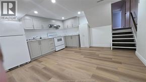 Windsor apartment for rent - A kitchen with white appliances and wooden floors.