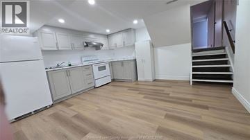 Windsor apartment for rent - A kitchen with white appliances and wooden floors.