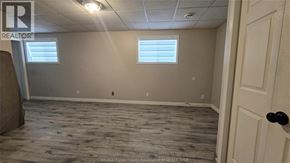 Windsor apartment for rent - A room with a wooden floor and a door on the right side.