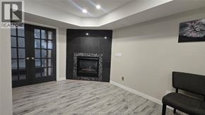 Windsor apartment for rent - A modern living room with a fireplace and a chair.