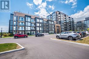 Oakville (Wm Westmount) condo for rent - A modern apartment complex with cars parked in front.