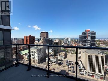 Hamilton (Corktown) condo for rent - A cityscape viewed from a high-rise building with a clear blue sky.