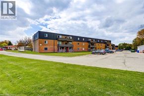 London apartment for rent - A large building with a parking lot in front of it.