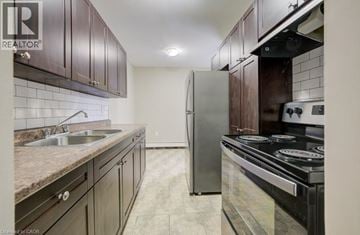 London apartment for rent - A kitchen with dark wood cabinets and a stainless steel refrigerator.