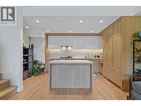 Burnaby apartment for rent - A modern kitchen with wooden cabinets and a central island.