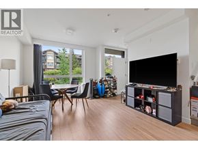 Burnaby apartment for rent - A living room with a grey couch and a television.