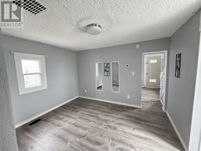 Sault Ste. Marie apartment for rent - A spacious room with grey walls and a window.