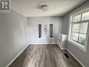 Sault Ste. Marie apartment for rent - A room with wood flooring and a window.