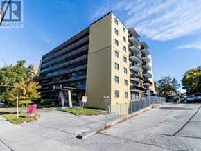 Toronto (Wexford-Maryvale) multi-family for rent - A tall building with a parking lot in front of it.