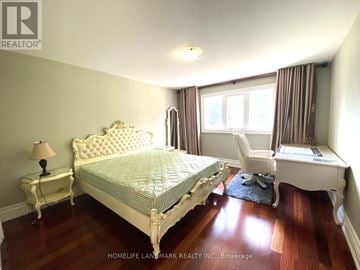 Toronto (Agincourt South-Malvern West) apartment for rent - A bedroom with a large bed and a chair.