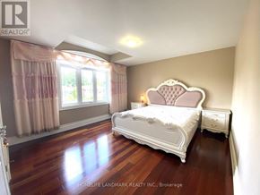 Toronto (Agincourt South-Malvern West) apartment for rent - A bedroom with a large bed and wooden floors.