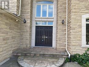 Toronto (Agincourt South-Malvern West) apartment for rent - A stone house with a black door and steps leading to it.