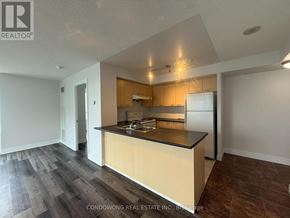Markham (Commerce Valley) condo for rent - A kitchen with a refrigerator, oven, and microwave.
