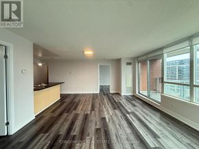 Markham (Commerce Valley) condo for rent - A spacious room with wood flooring and a large window.