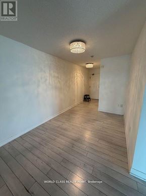 Toronto (Bayview Village) condo for rent - A room with wooden flooring and a chandelier.