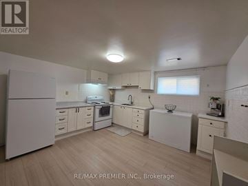 Vaughan (West Woodbridge) apartment for rent - A white kitchen with wooden floors and white appliances.