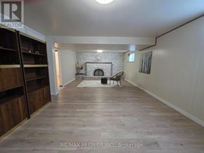 Vaughan (West Woodbridge) apartment for rent - A spacious room with a fireplace and wooden flooring.