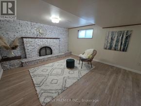 Vaughan (West Woodbridge) apartment for rent - A living room with a fireplace and a chair.