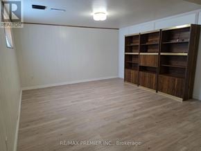 Vaughan (West Woodbridge) apartment for rent - A room with wooden flooring and a large wooden shelving unit.