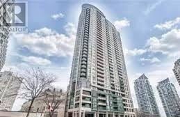 Mississauga (City Centre) house for rent - A tall residential building stands in front of other buildings.