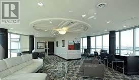 Mississauga (City Centre) house for rent - A realtor's office with a white couch and a black and white checkered floor.