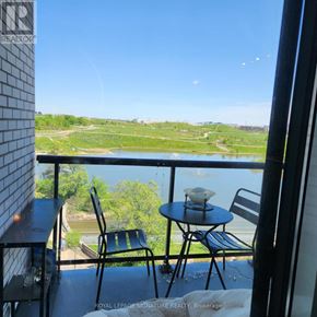 Toronto (Downsview-Roding-Cfb) condo for rent - A balcony with a table and chairs overlooking a green landscape.