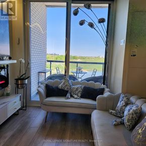 Toronto (Downsview-Roding-Cfb) condo for rent - A living room with a couch and a view of the outside.