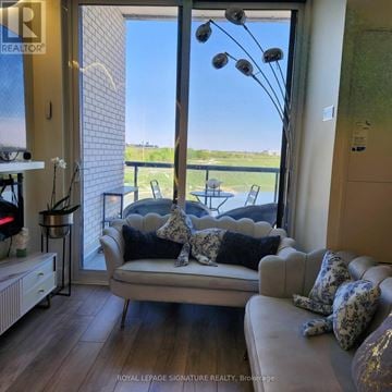 Toronto (Downsview-Roding-Cfb) condo for rent - A living room with a couch and a view of the outside.