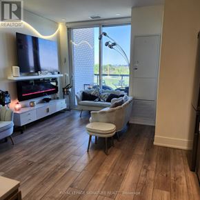 Toronto (Downsview-Roding-Cfb) condo for rent - A living room with a television, a couch, a chair, and a floor lamp.