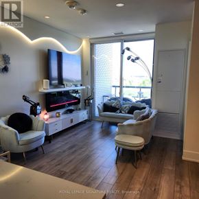 Toronto (Downsview-Roding-Cfb) condo for rent - A living room with a television, couch, and chairs.