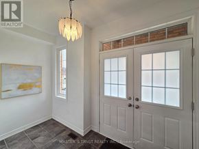 Markham (Wismer) apartment for rent - A room with a white door and a chandelier hanging from the ceiling.