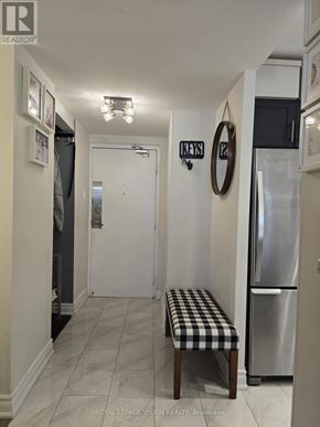 Toronto (Victoria Village) condo for rent - A kitchen with a fridge and a bench.